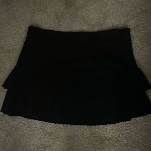 BCBG pleated skirt buttons in the side.